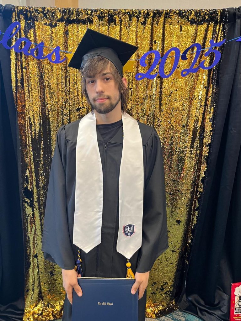 A person is holding a diploma with "2013" written above them and wearing a graduation cap.