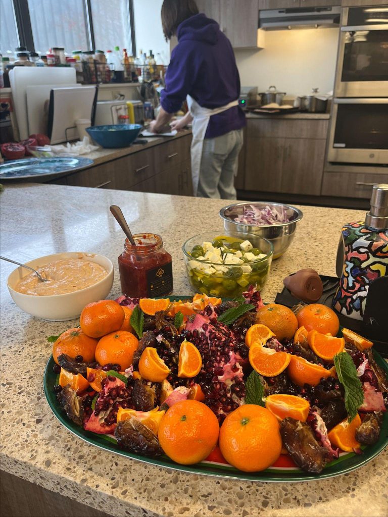 Person is preparing food with various ingredients and utensils at a counter.